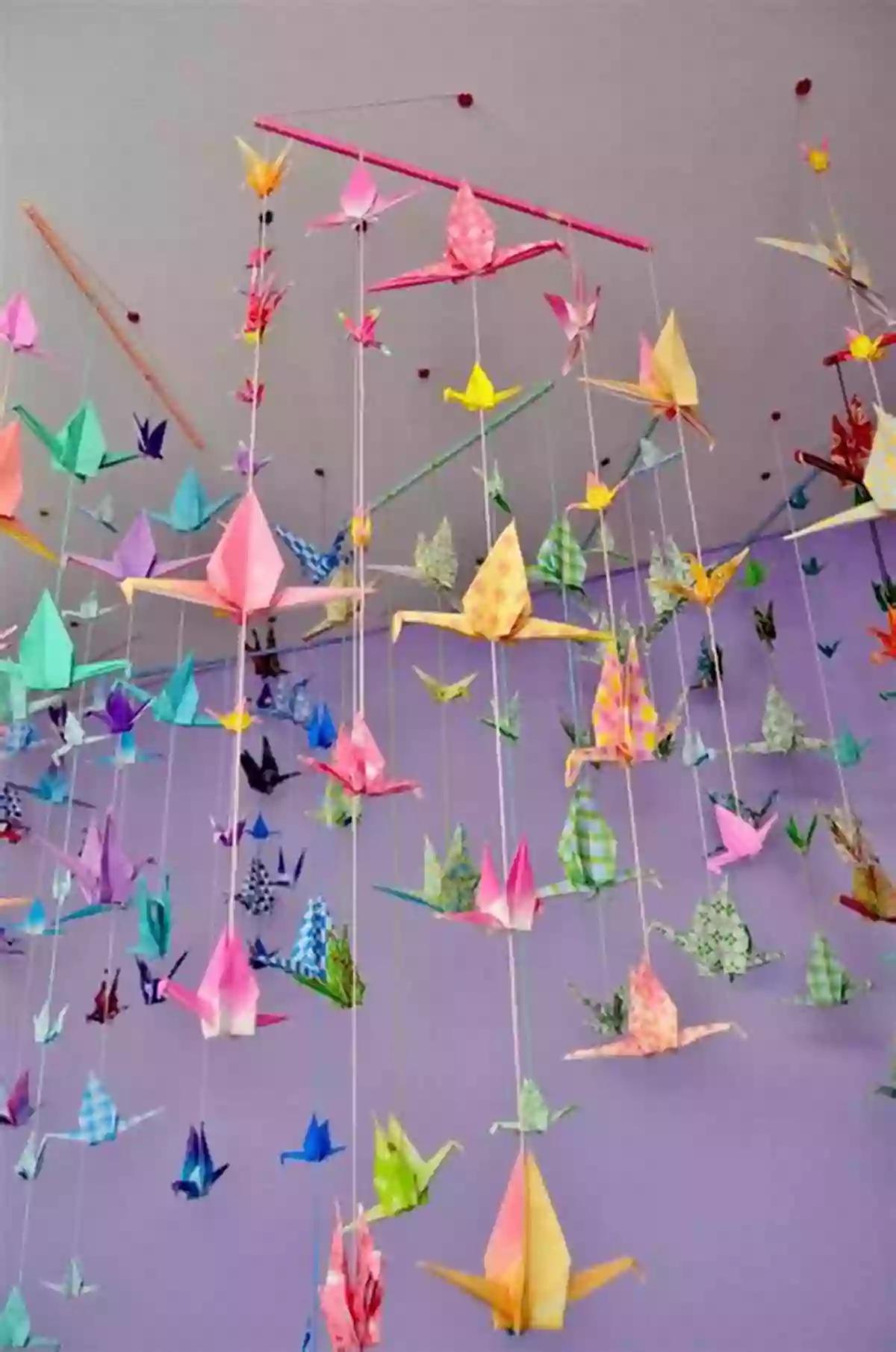 A Display Of Colorful Paper Cranes Hanging From Strings Senbazuru: One Thousand Steps To Happiness Fold By Fold