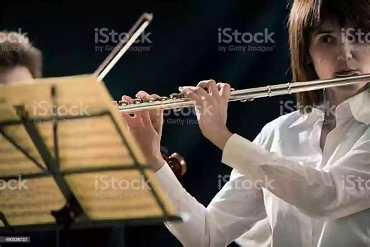 Flutist Performing On Stage With Vibrant Colors And Atmospheric Lighting F Is For Flute: A Z Music Vocabulary For Kids